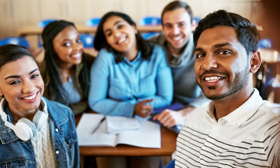 College is awesome. Cropped portrait of a group of young university students sitting in class
